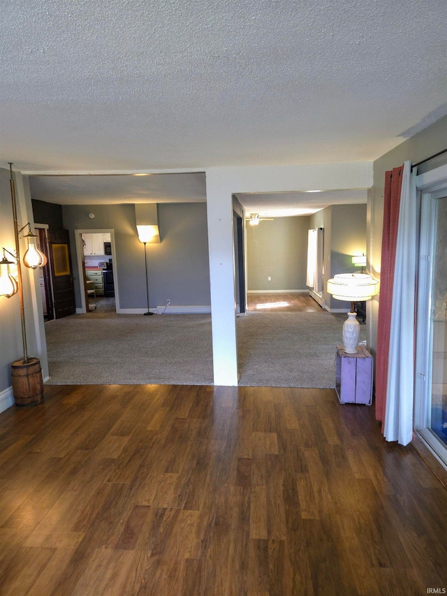 unfurnished room featuring dark hardwood / wood-style flooring and a textured ceiling