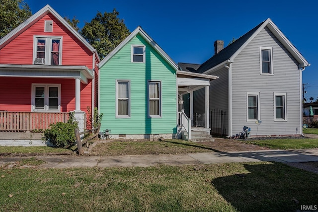 view of front of house with a front yard and a porch