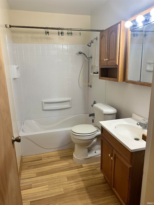 full bathroom featuring bathtub / shower combination, hardwood / wood-style floors, vanity, and toilet