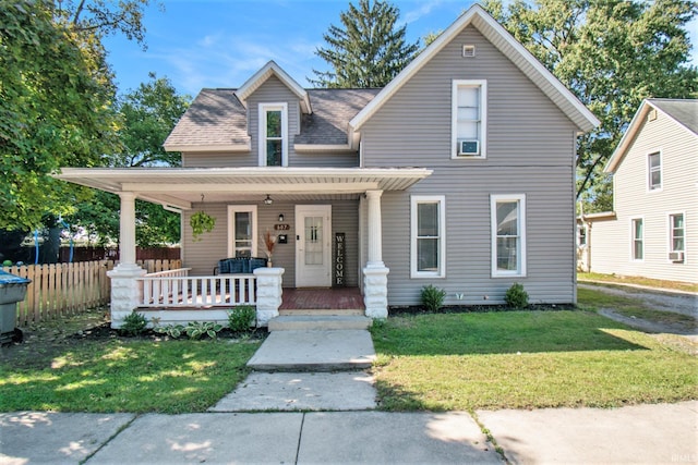 view of front of home featuring covered porch and a front yard