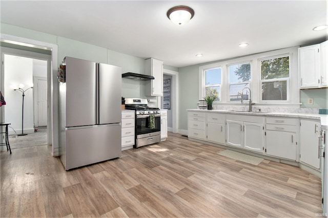 kitchen featuring light hardwood / wood-style floors, appliances with stainless steel finishes, sink, and white cabinetry