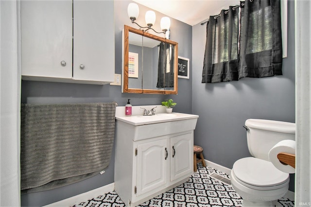 bathroom featuring tile patterned flooring, vanity, and toilet