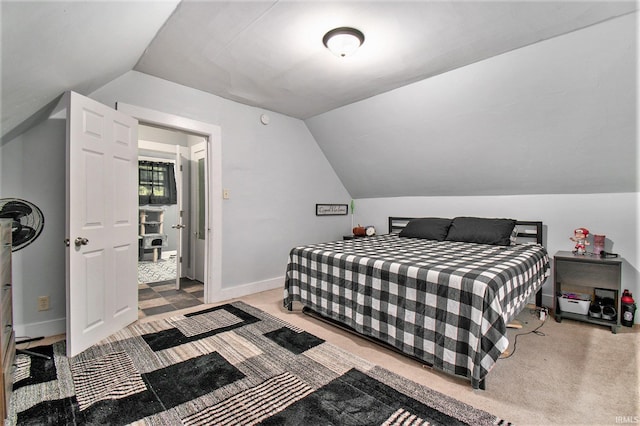 carpeted bedroom with lofted ceiling