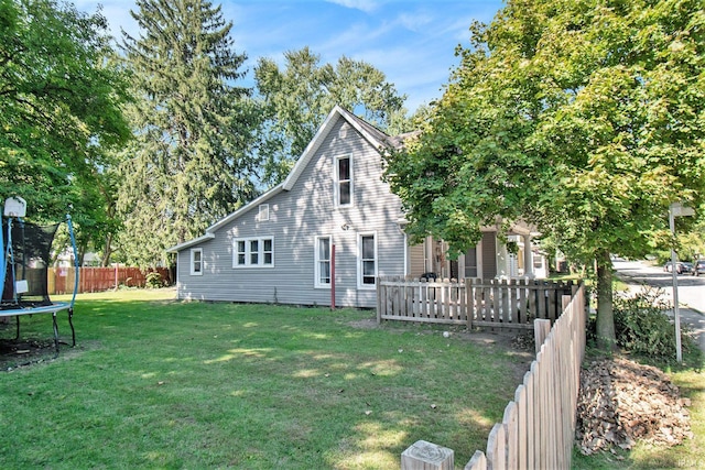 view of front of home featuring a trampoline and a front lawn