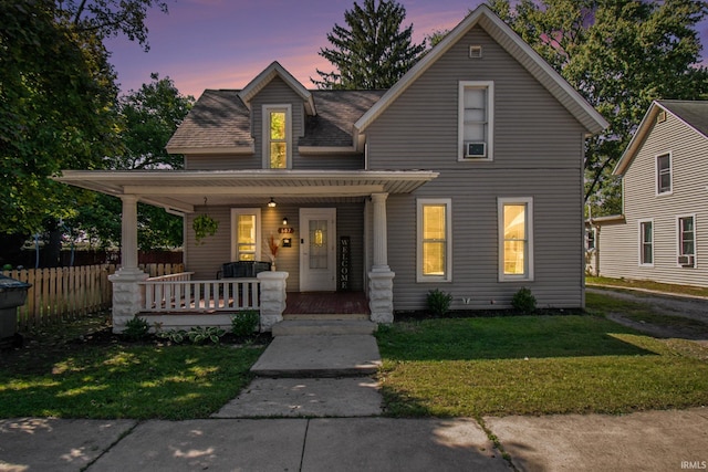 view of front of property with a yard and a porch