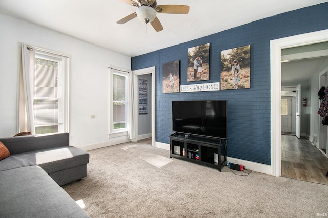 living room featuring wood-type flooring and ceiling fan