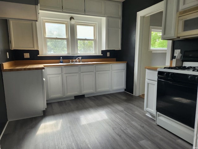 kitchen with white cabinetry, white appliances, wooden counters, light wood-type flooring, and sink