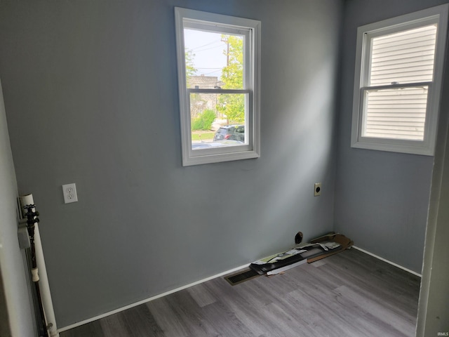 laundry room with hookup for an electric dryer and hardwood / wood-style flooring