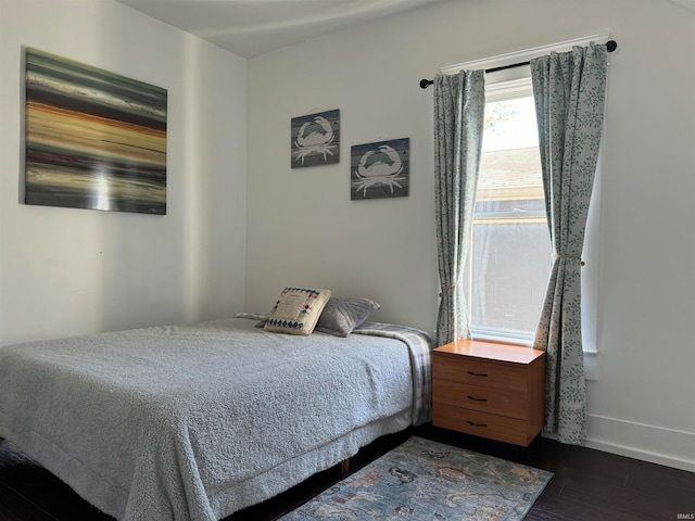 bedroom with dark hardwood / wood-style floors