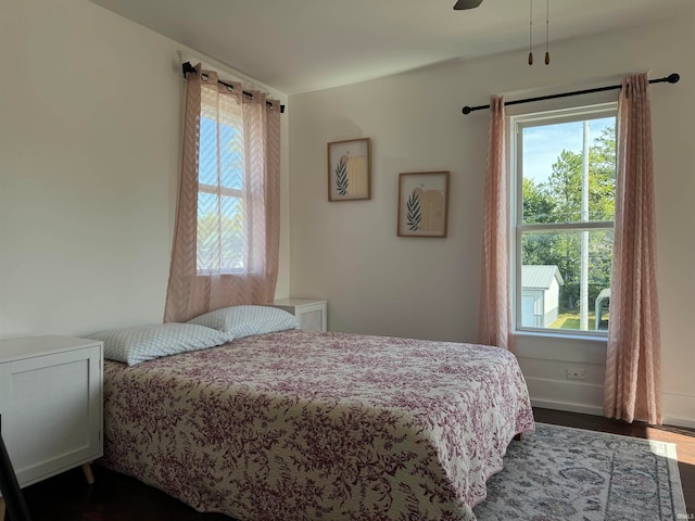 bedroom featuring ceiling fan and dark hardwood / wood-style floors