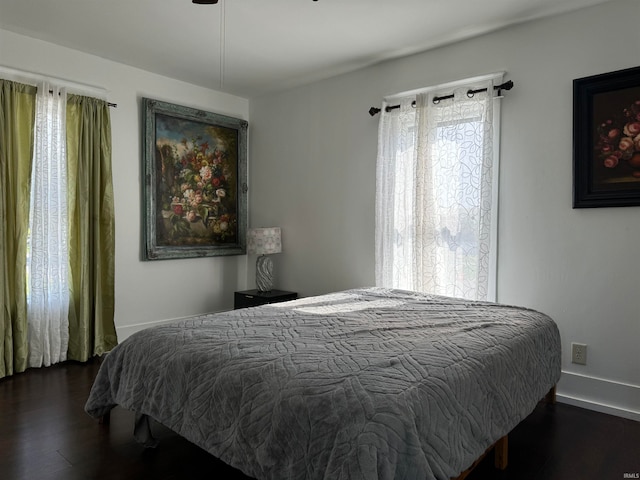 bedroom with dark wood-type flooring