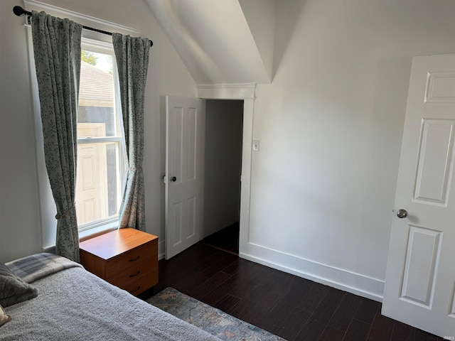 bedroom featuring dark hardwood / wood-style floors and vaulted ceiling