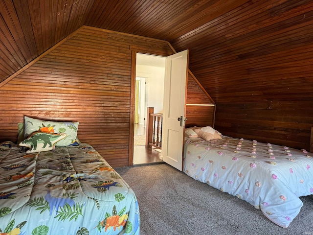 unfurnished bedroom with wood walls, vaulted ceiling, carpet, and wooden ceiling