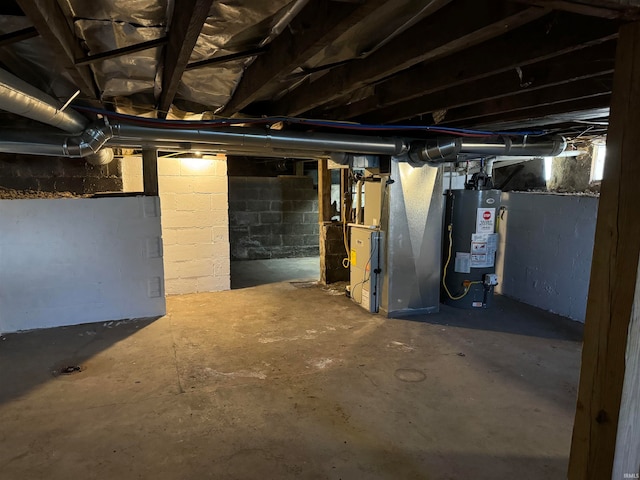 basement featuring heating unit and water heater