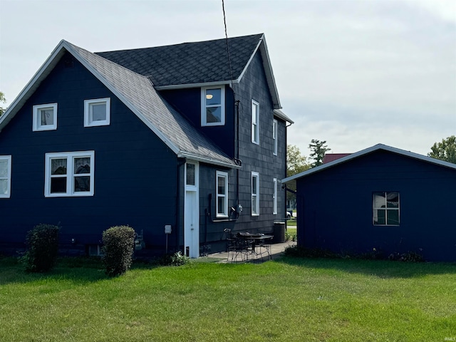 back of property featuring a yard and a patio