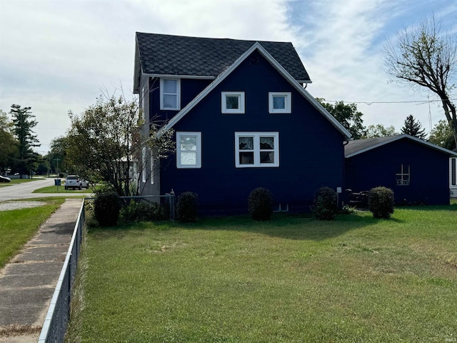 view of side of property featuring a yard