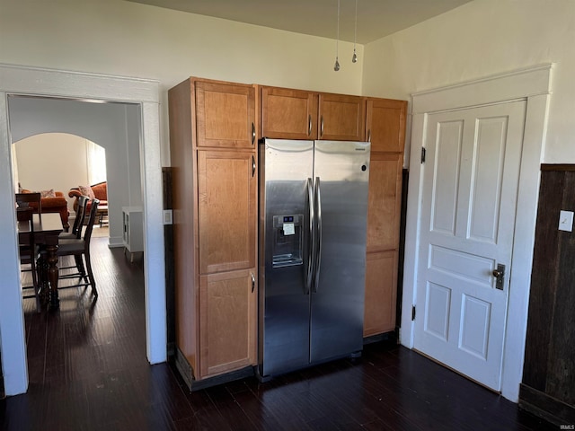 kitchen featuring stainless steel fridge and dark wood-type flooring