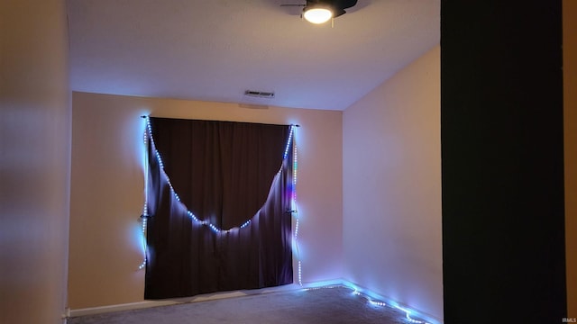 spare room with ceiling fan and carpet floors