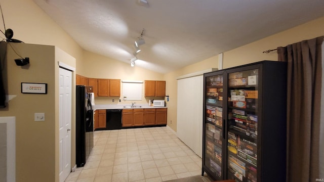 kitchen with black appliances, lofted ceiling, sink, and track lighting