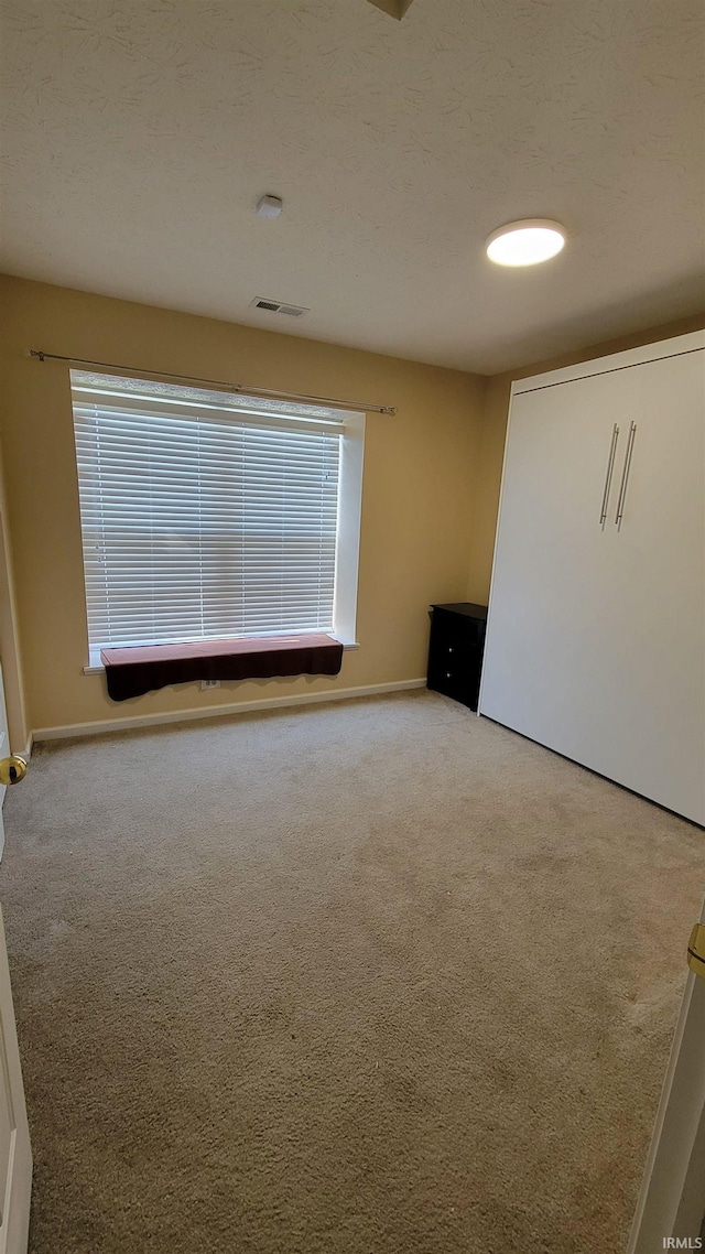 empty room with light colored carpet