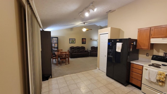 kitchen with black fridge, white range with electric cooktop, vaulted ceiling, light carpet, and ceiling fan