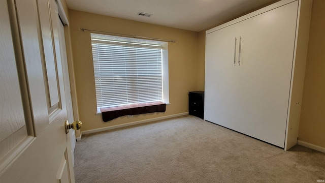 unfurnished bedroom with light carpet