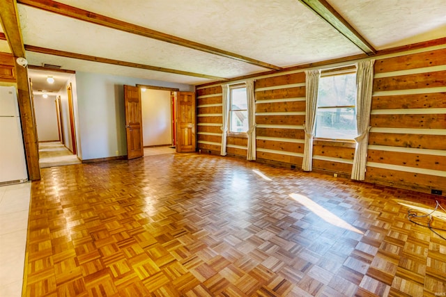 unfurnished room with a textured ceiling and parquet floors