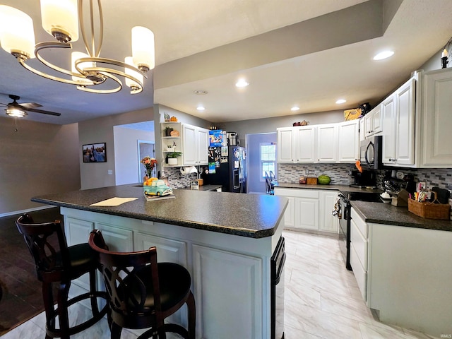 kitchen featuring white cabinets, decorative light fixtures, backsplash, black refrigerator with ice dispenser, and electric stove