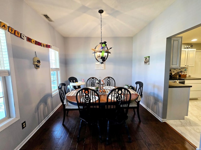 dining room featuring hardwood / wood-style flooring, a chandelier, and plenty of natural light