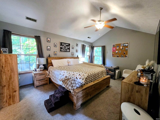 bedroom with vaulted ceiling, multiple windows, carpet floors, and ceiling fan