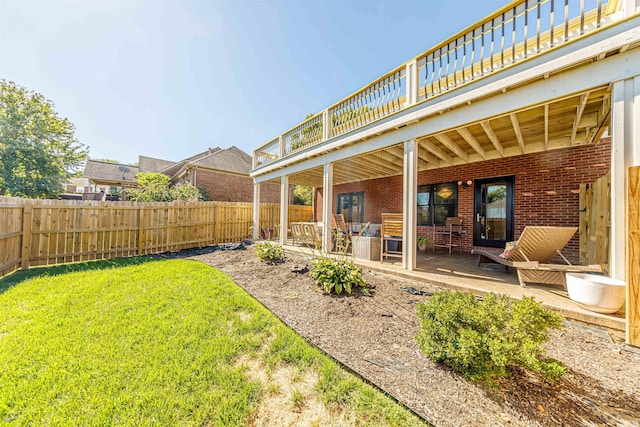 view of yard with a wooden deck and a patio area