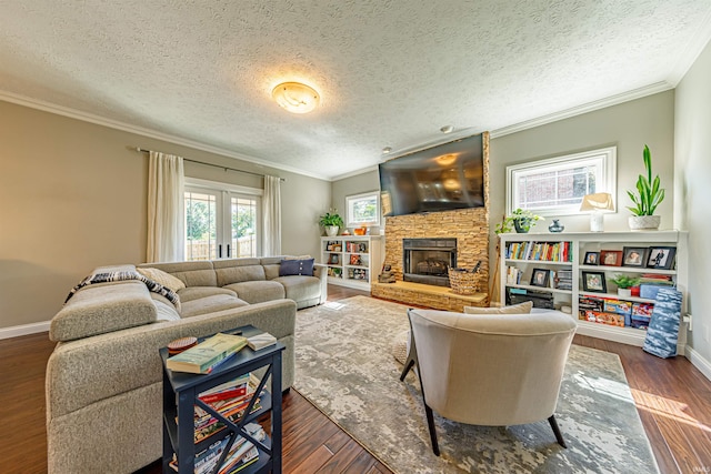 living room with a textured ceiling, a stone fireplace, ornamental molding, and dark hardwood / wood-style flooring