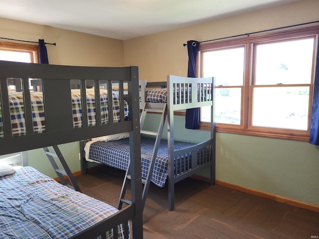 carpeted bedroom with multiple windows