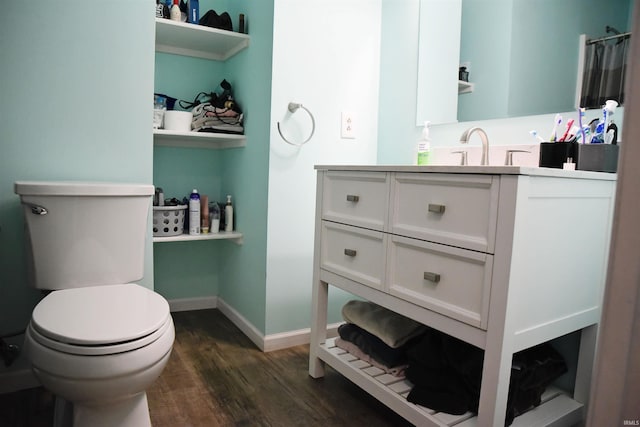 bathroom featuring hardwood / wood-style flooring, vanity, and toilet