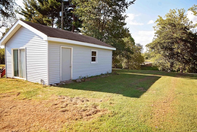 view of outbuilding featuring a lawn