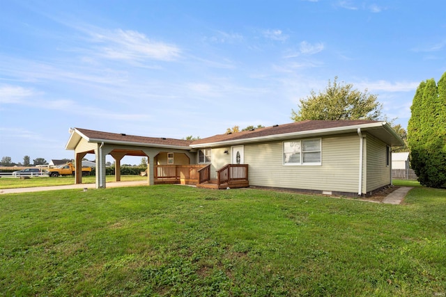 rear view of property featuring a deck and a yard