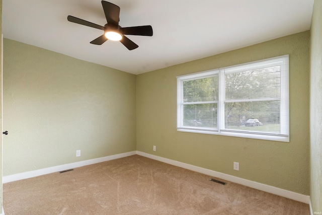 carpeted empty room with ceiling fan