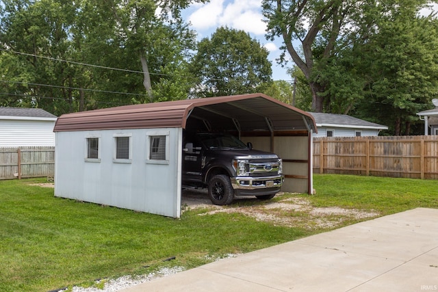 view of outbuilding featuring a lawn and a carport