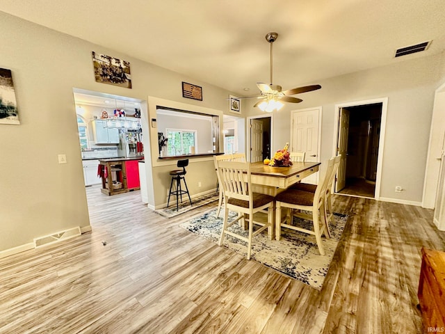 dining room featuring wood-type flooring and ceiling fan