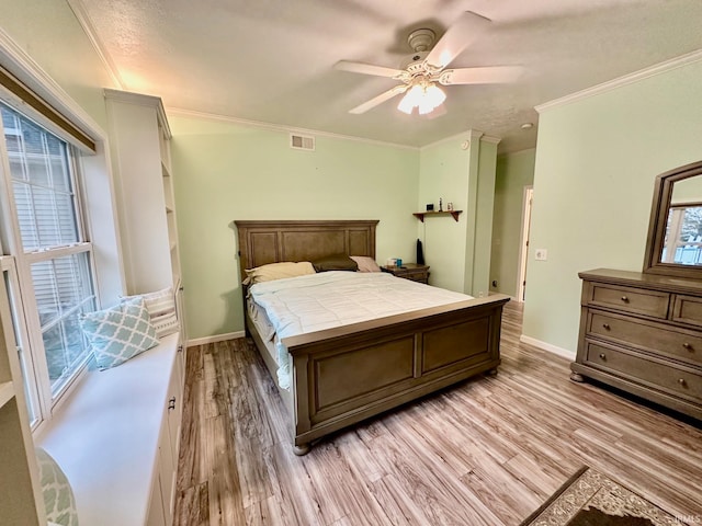 bedroom featuring ceiling fan, crown molding, and light hardwood / wood-style floors