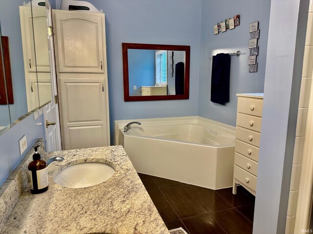 bathroom featuring a bathtub, vanity, and tile patterned floors