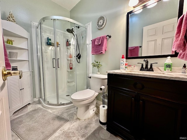 bathroom featuring vanity, toilet, and an enclosed shower