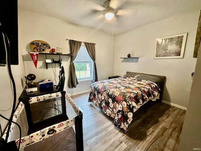 bedroom with wood-type flooring and ceiling fan