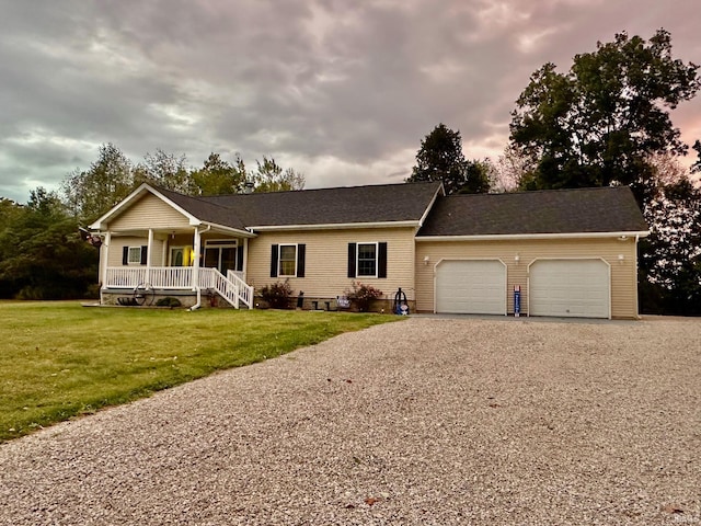 ranch-style home with a porch, a garage, and a front lawn