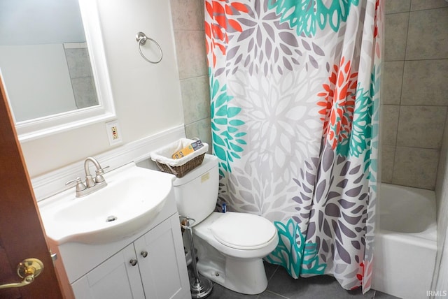 full bathroom featuring vanity, toilet, shower / bath combo with shower curtain, and tile patterned floors