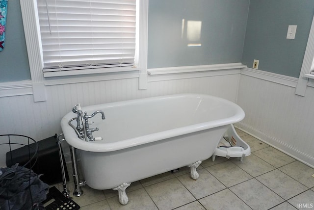 bathroom with a bathtub and tile patterned flooring