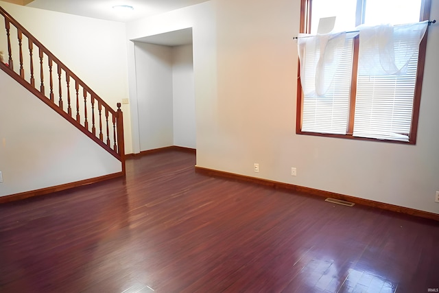 spare room with dark wood-type flooring