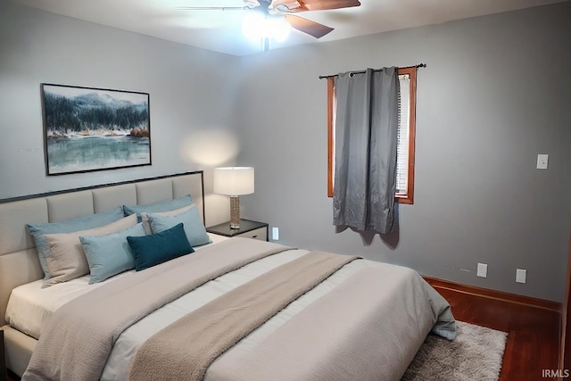 bedroom with ceiling fan and dark wood-type flooring