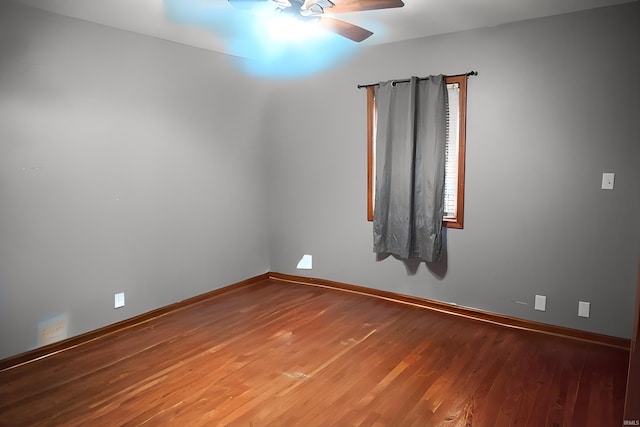 empty room featuring hardwood / wood-style floors and ceiling fan