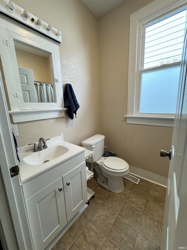 bathroom with vanity and toilet